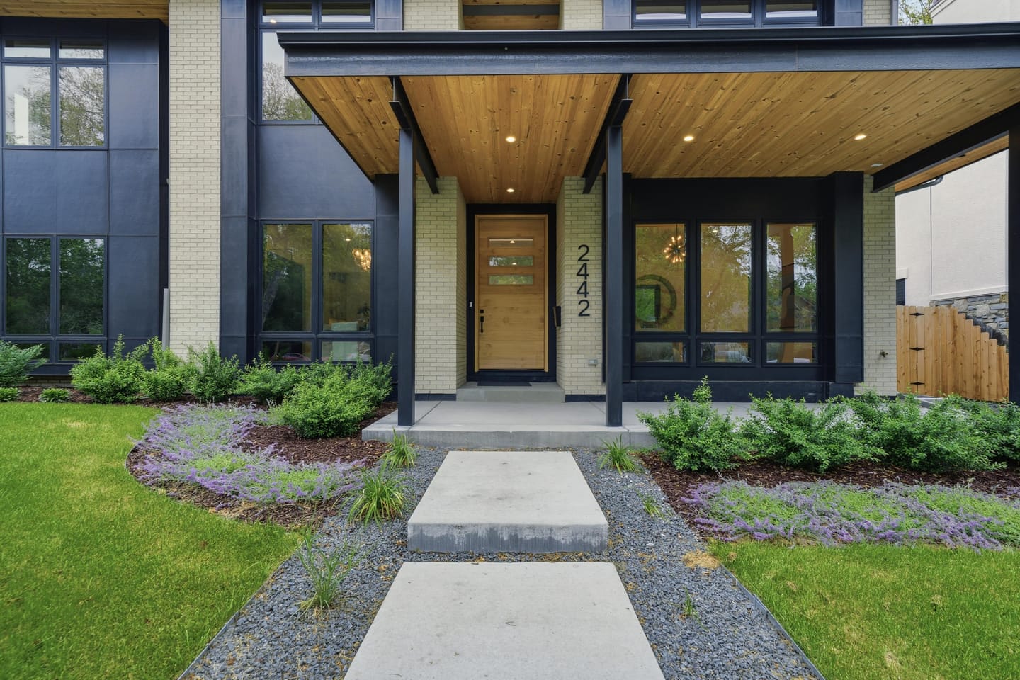 Covered front entry with wood soffit and Select Alder door at 2442 Saint Paul