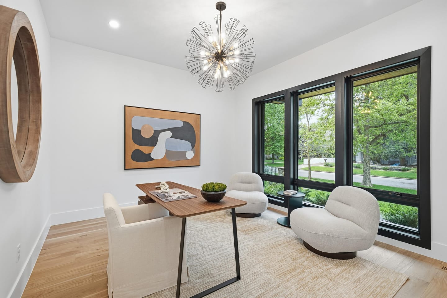 Front sitting room with white oak floors and black-framed glazing