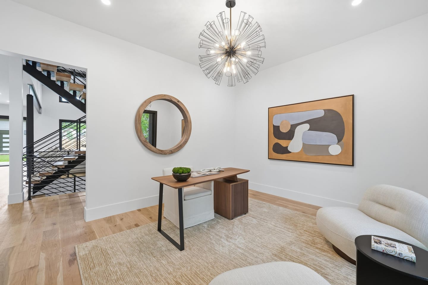 Front sitting room with white oak floors and black-framed glazing