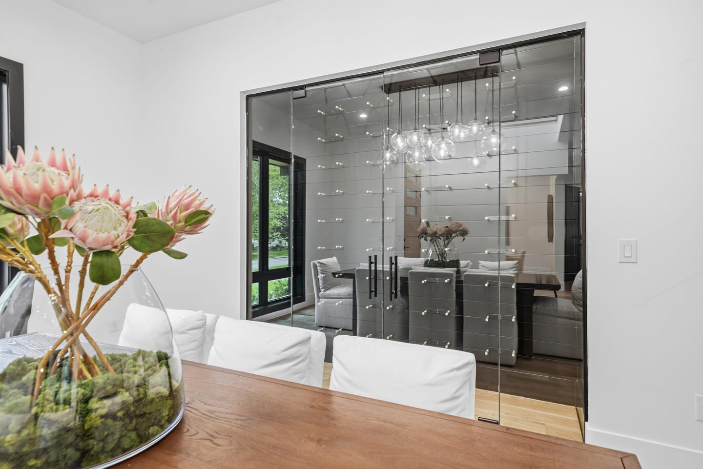 Glass-enclosed wine room adjoining the dining room