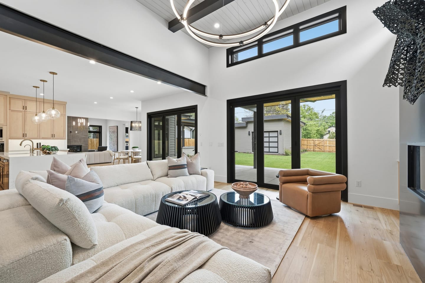 Great room with full-height charcoal fireplace wall and white oak floors