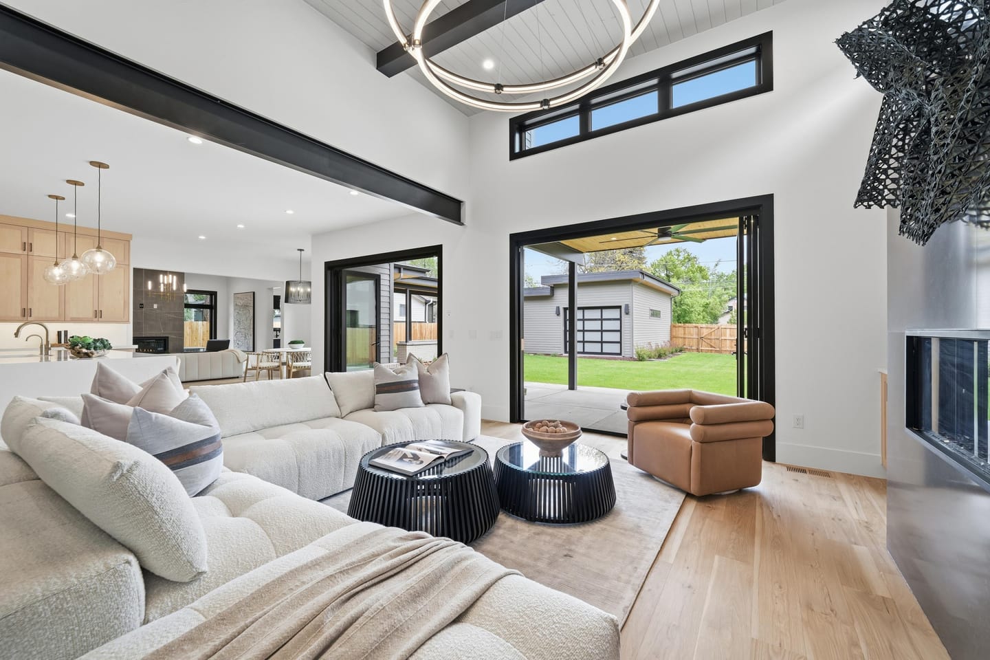 Great room with full-height charcoal fireplace wall and white oak floors