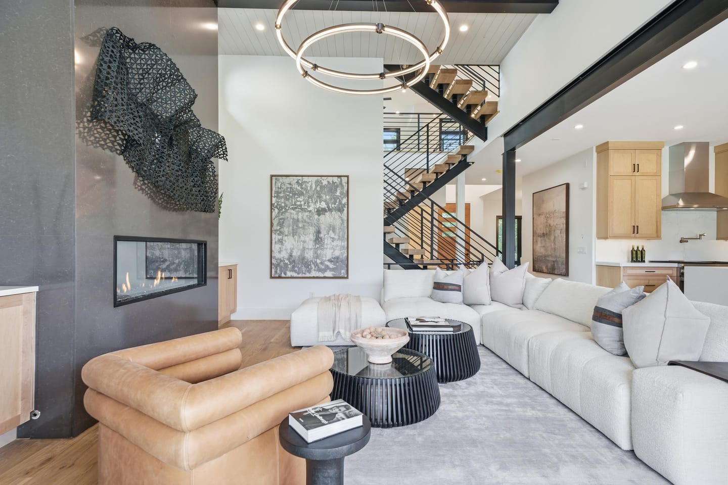 Great room with full-height charcoal fireplace wall and white oak floors