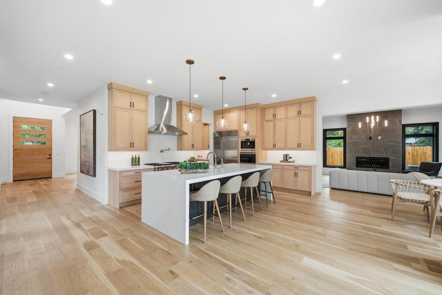 Kitchen and island seating opening to the great room