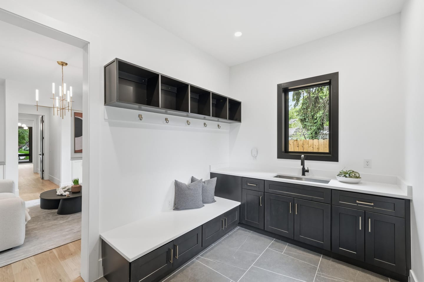 Mudroom with built-in bench, lockers and sink