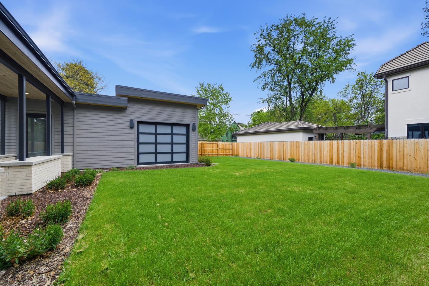 Private rear lawn with covered breezeway and three-car garage