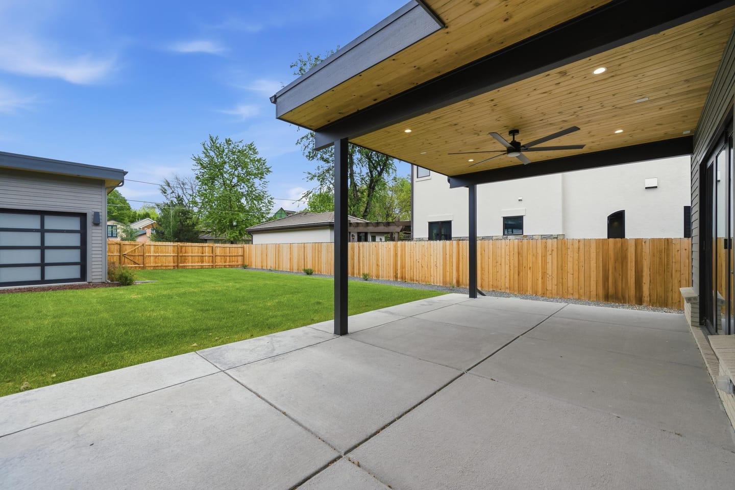 Private rear lawn with covered breezeway and three-car garage