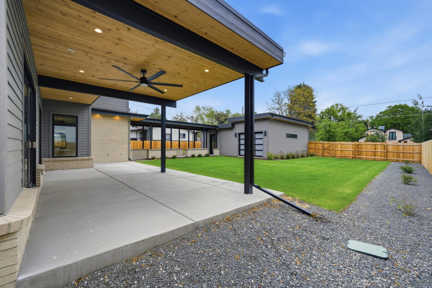 Private rear lawn with covered breezeway and three-car garage