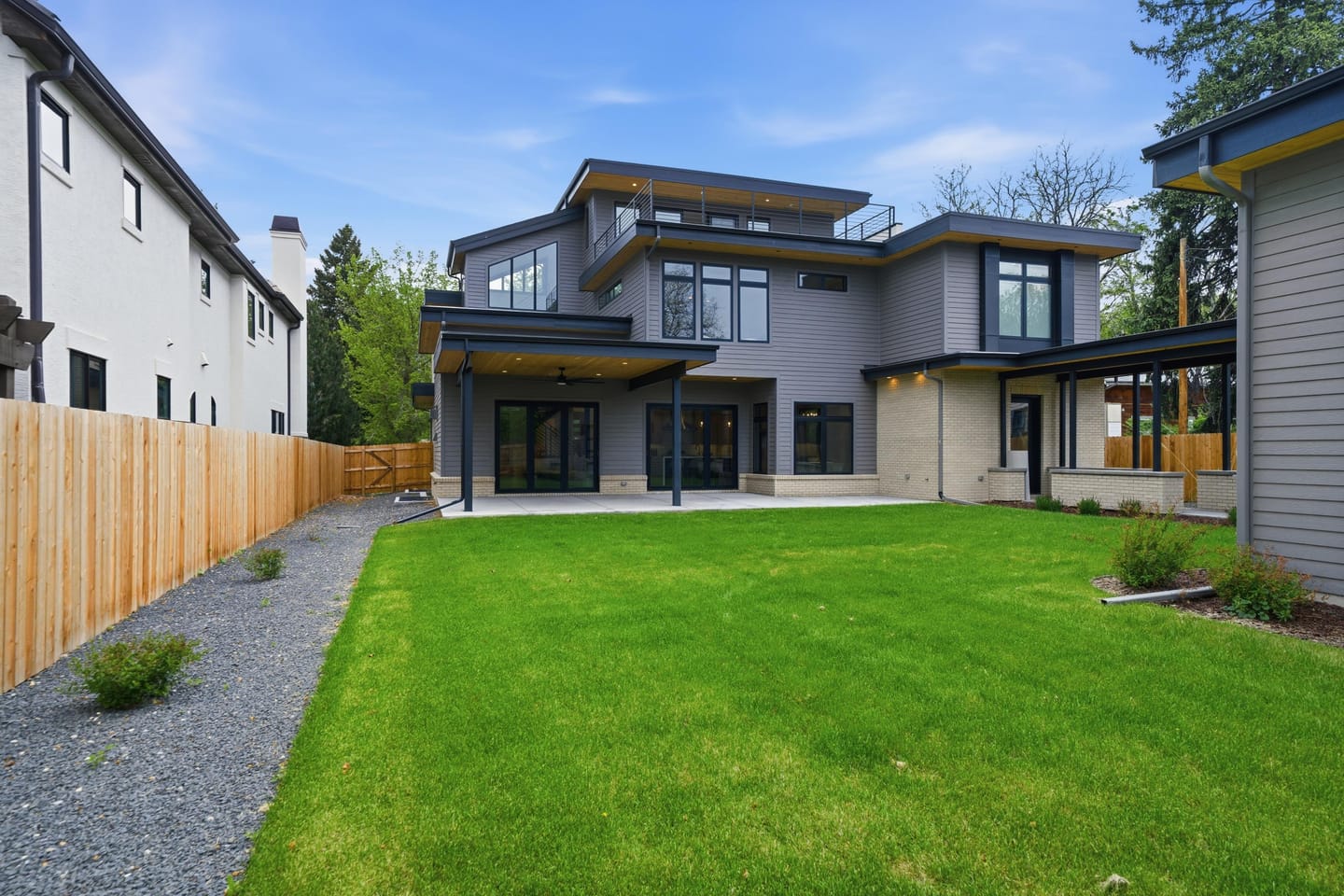 Private rear lawn with covered breezeway and three-car garage
