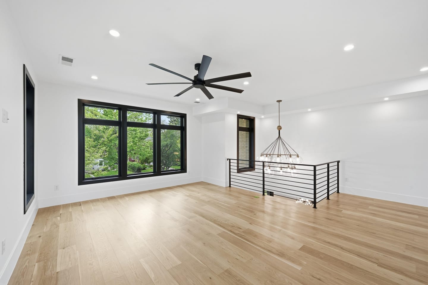 Floating white oak stair with blackened steel and cable railing