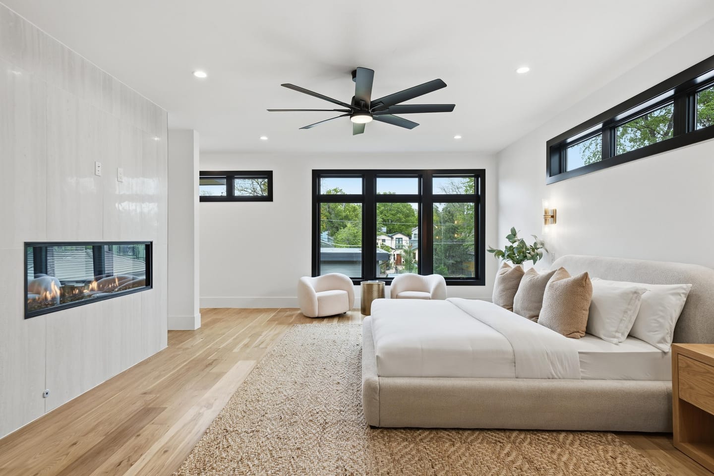 Primary suite with linear fireplace and black-framed glazing