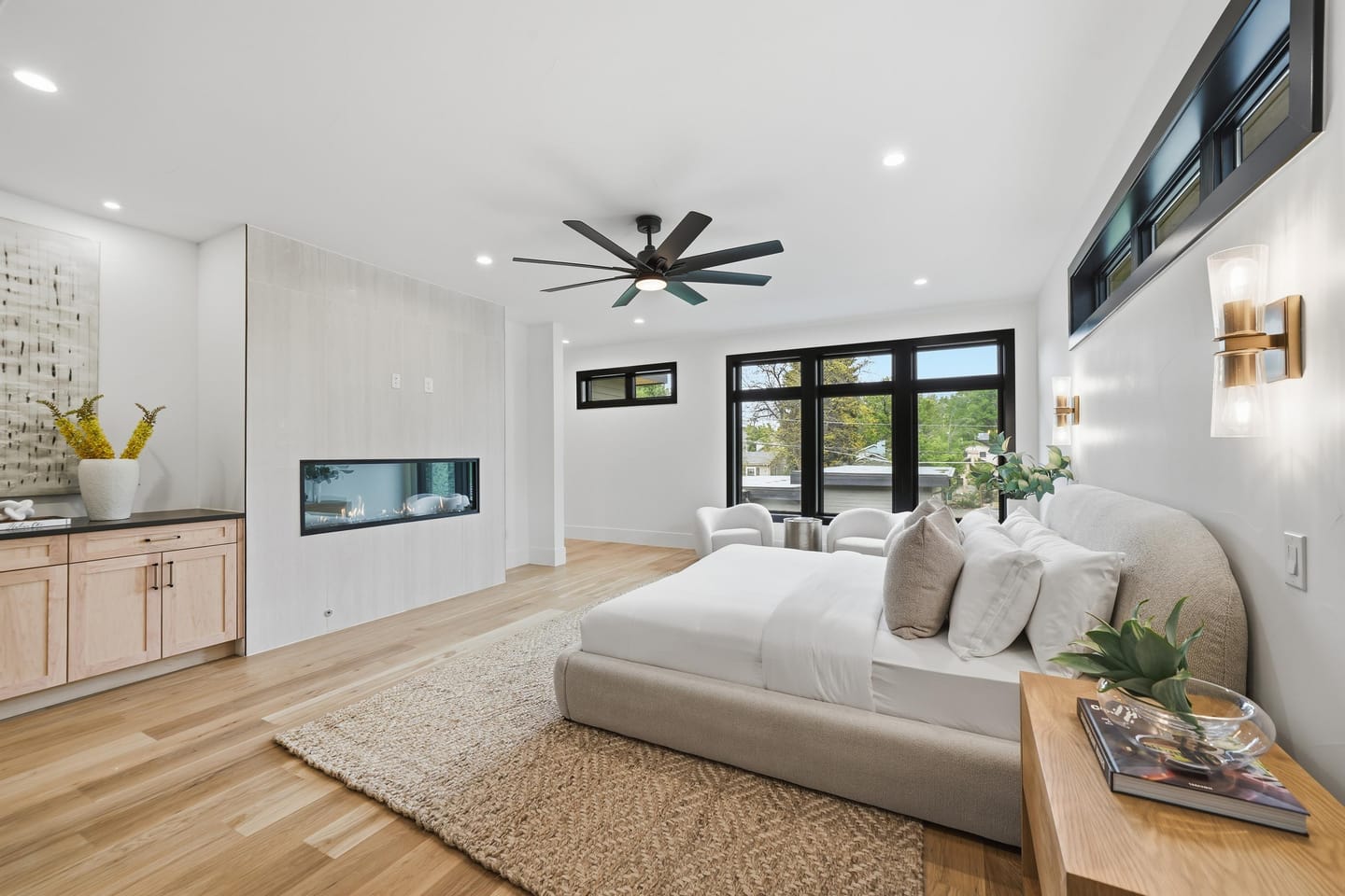 Primary suite with linear fireplace and black-framed glazing