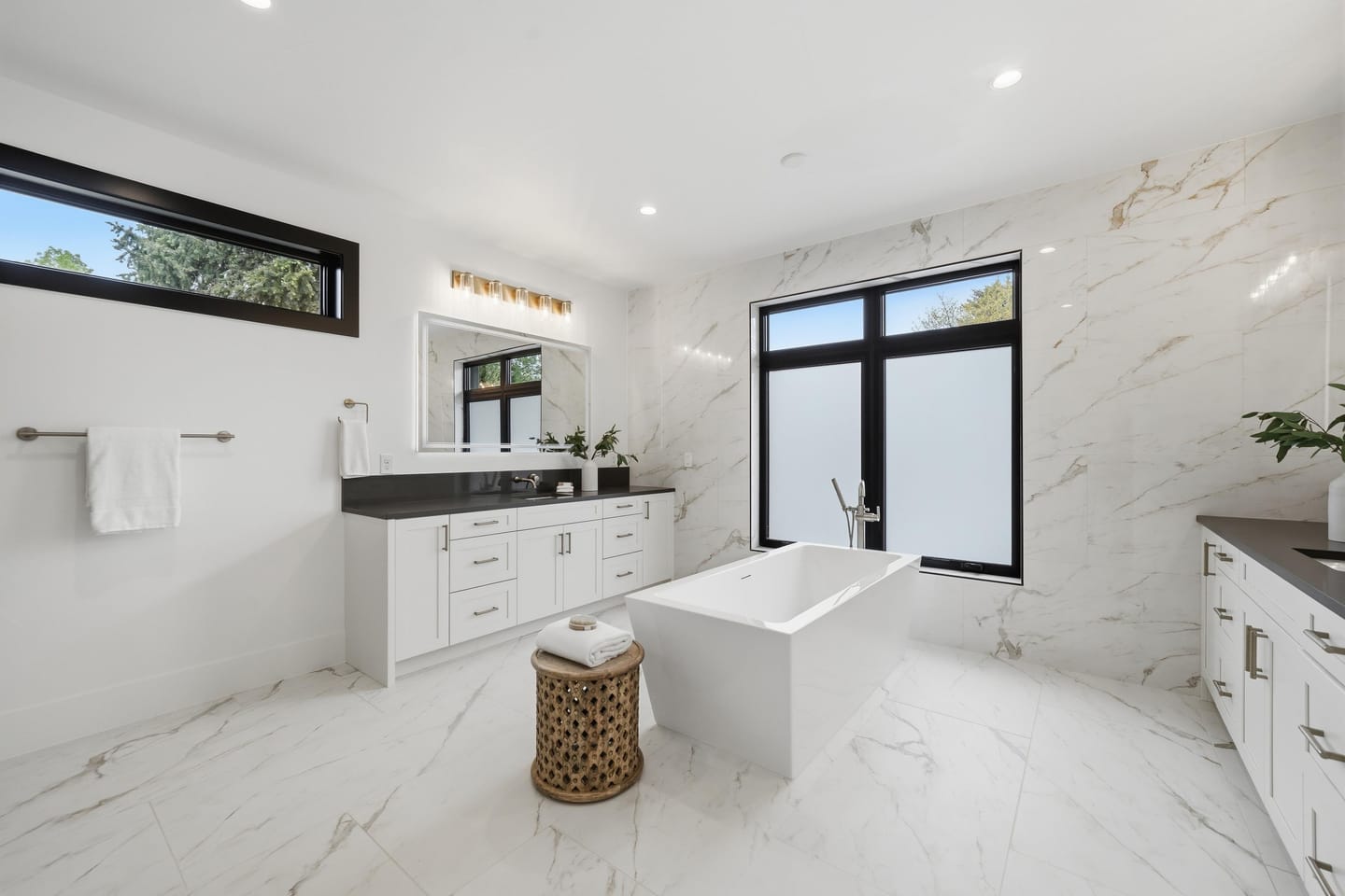 Primary bath with freestanding tub and large-format porcelain