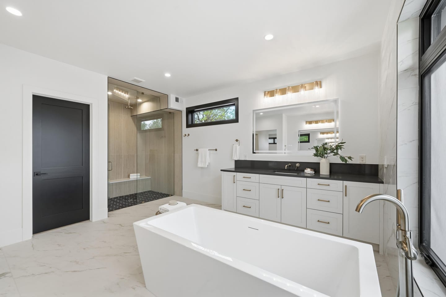Primary bath with freestanding tub and large-format porcelain