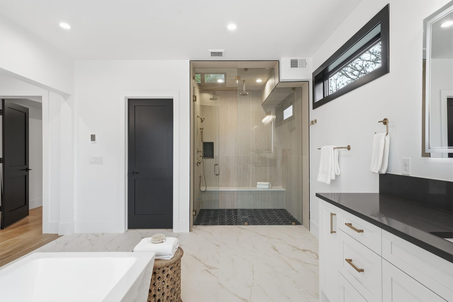 Primary bath with freestanding tub and large-format porcelain