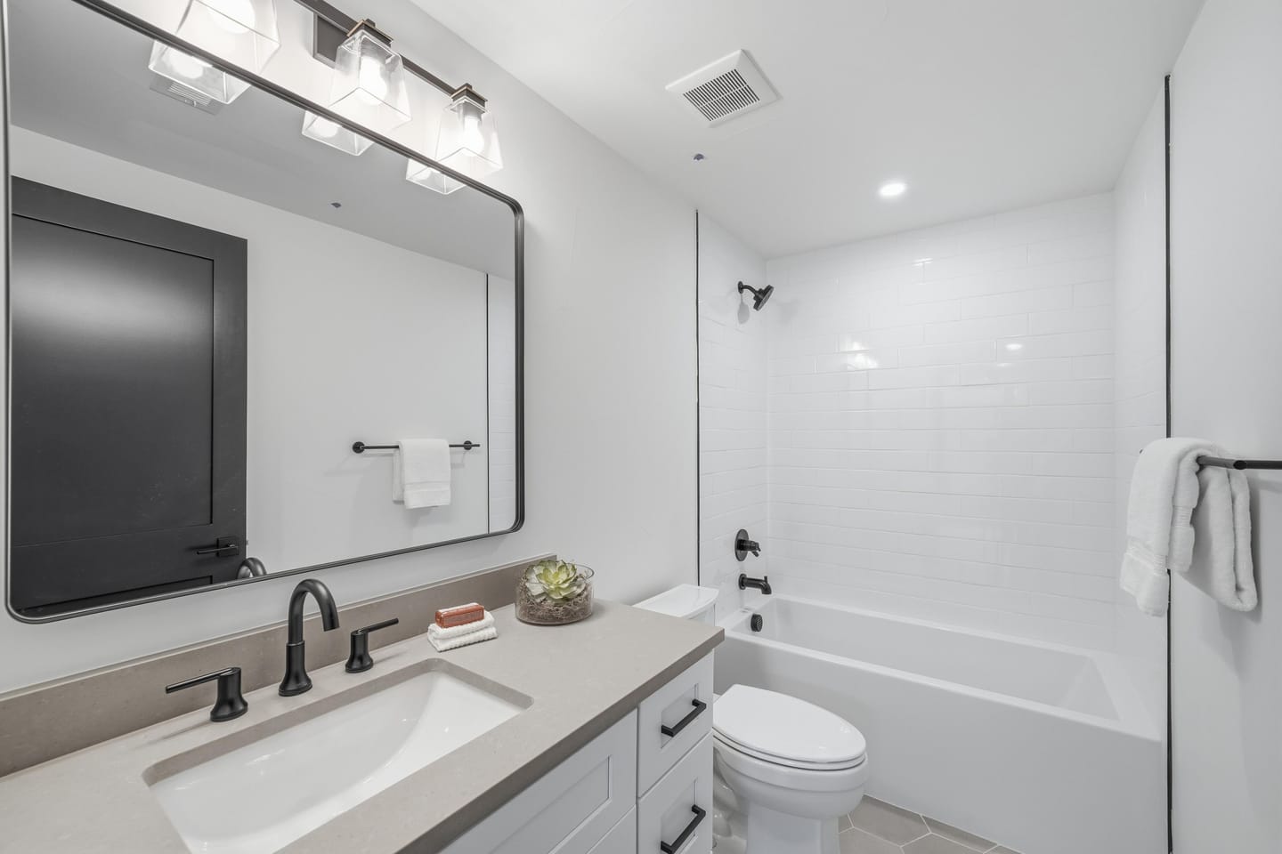 Secondary bedroom with panel-detail accent wall