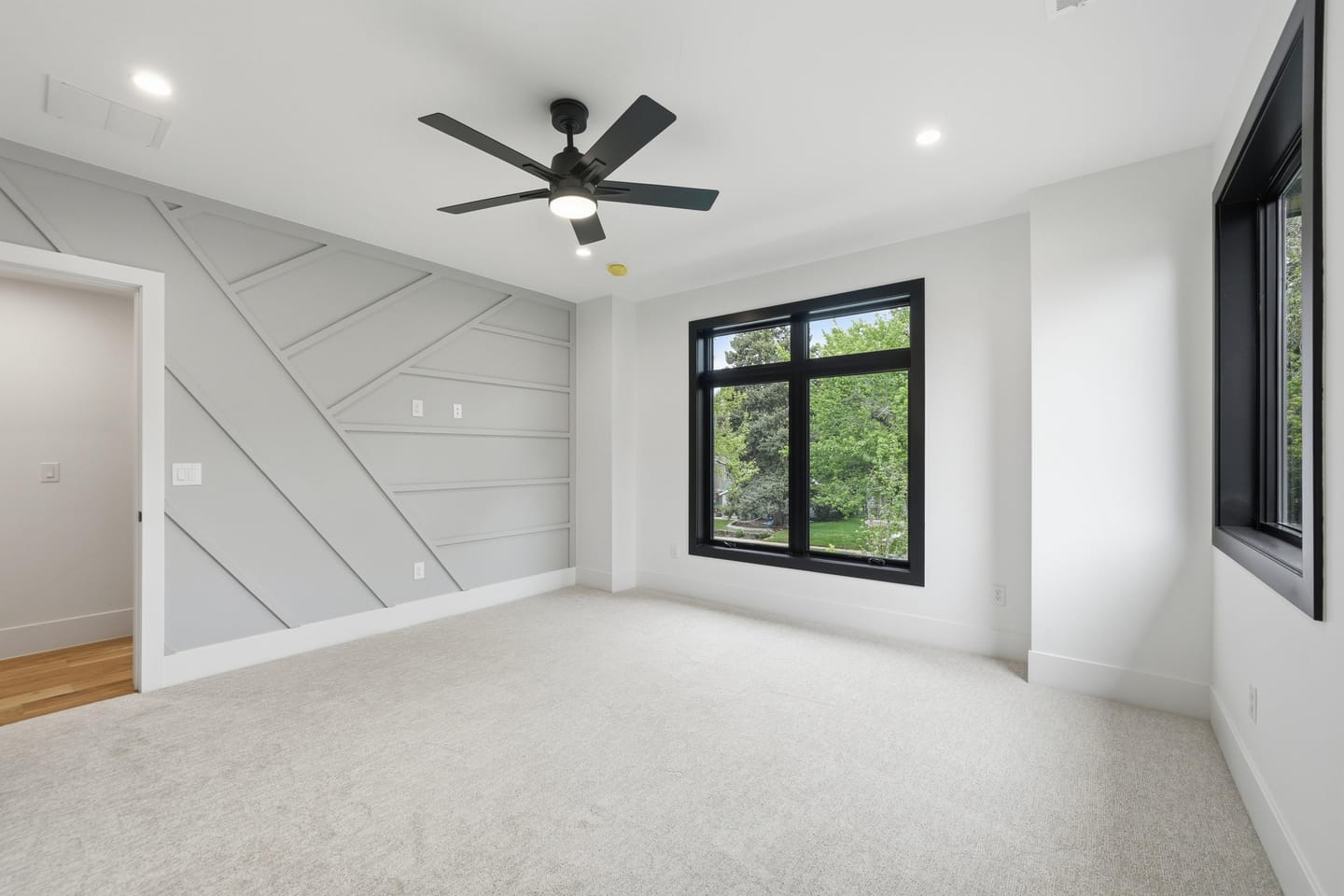 Secondary bedroom with panel-detail accent wall