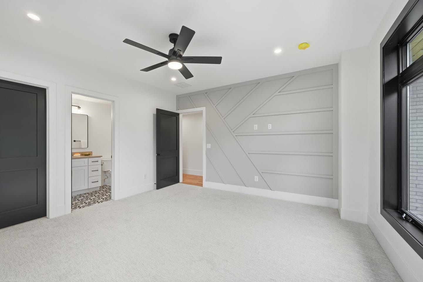 Secondary bedroom with panel-detail accent wall