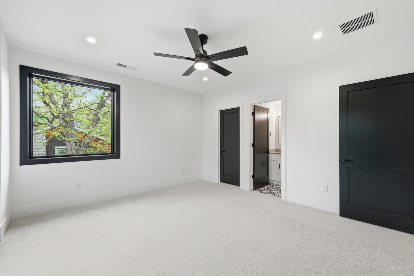Secondary bedroom with panel-detail accent wall