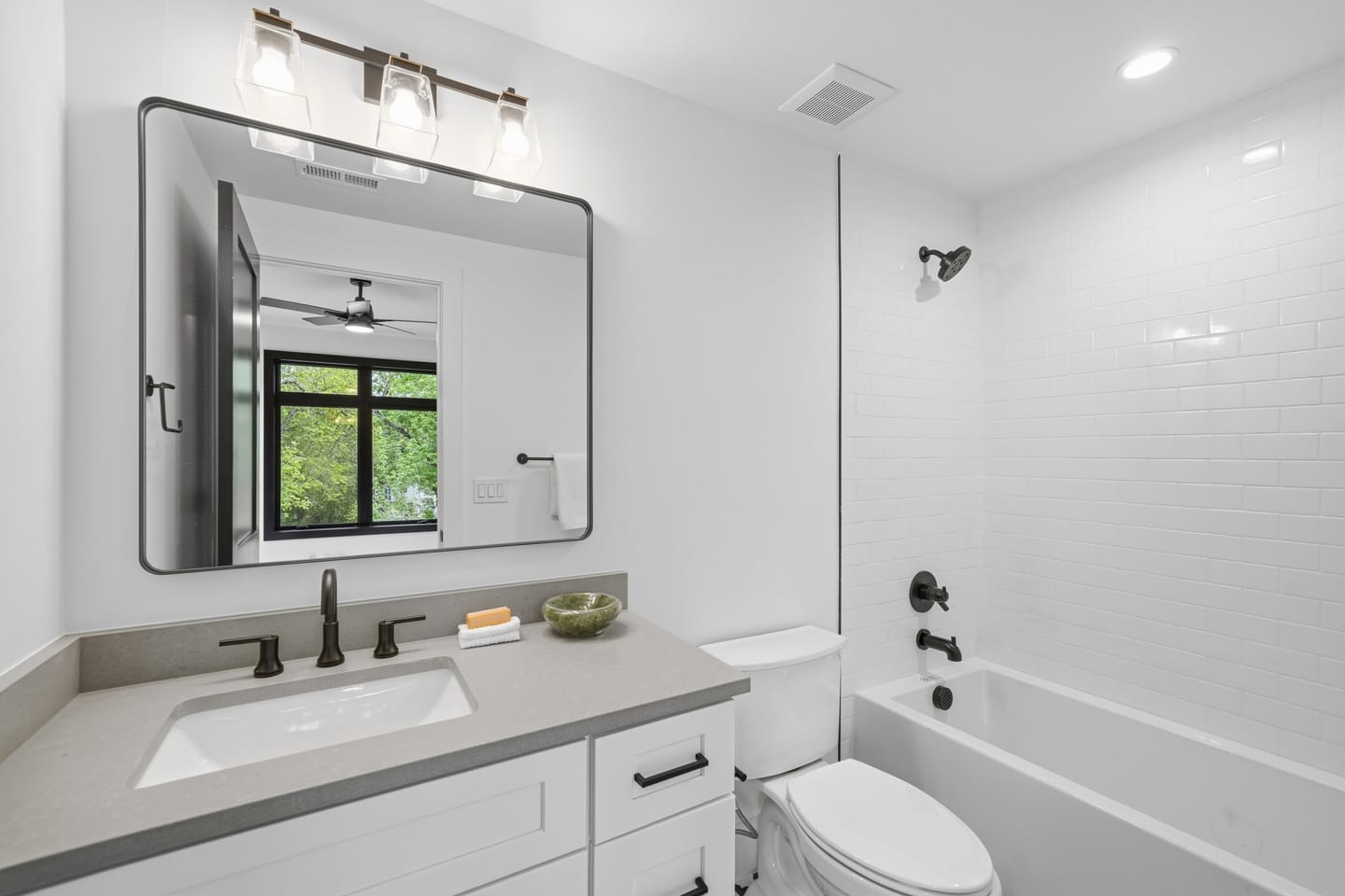 Secondary bedroom with panel-detail accent wall