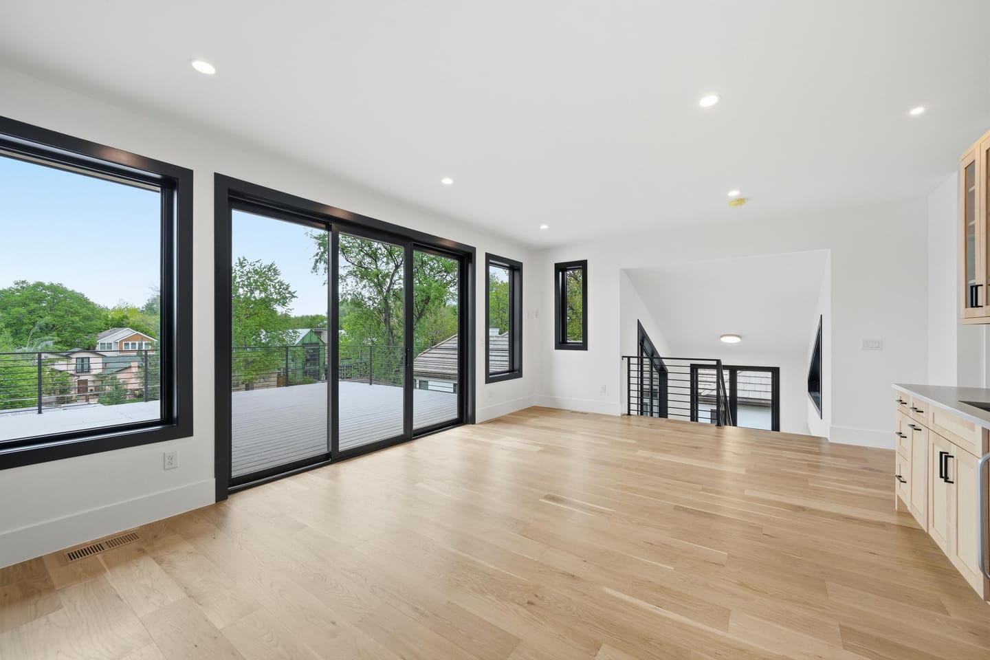 Upper-level lounge with wet bar opening to the rooftop deck