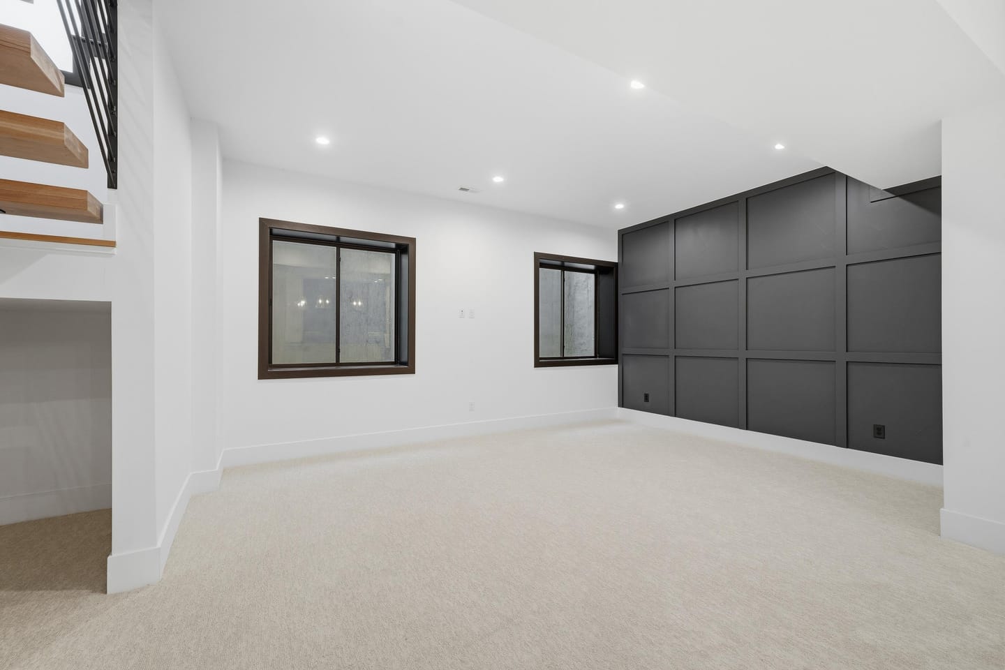 Lower-level recreation room with wet bar and stair