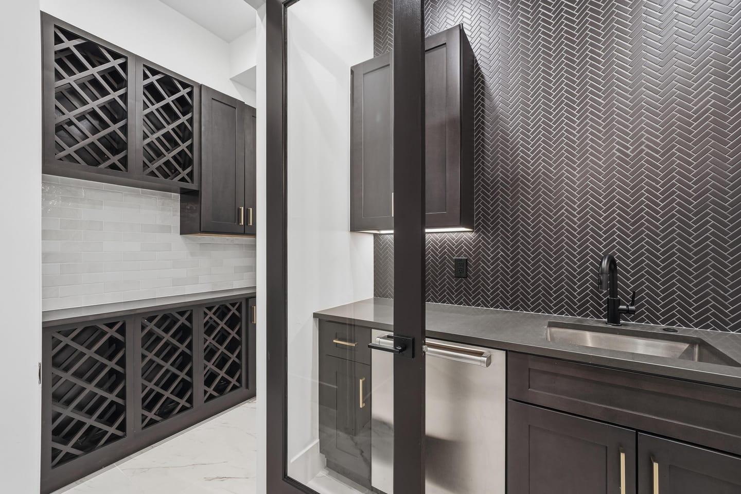 Lower-level recreation room with wet bar and stair